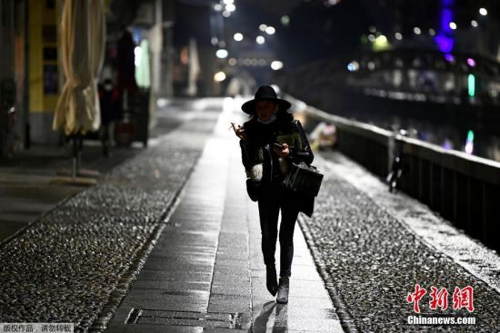 当地时间10月22日，意大利米兰，一名女士走在空旷的街头上。
