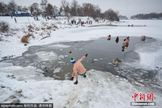 当地时间1月17日，波兰克拉科夫，当地气温已降至零下12摄氏度，民众在湖水中进行冬泳。